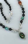 African glass and hand coiled accents